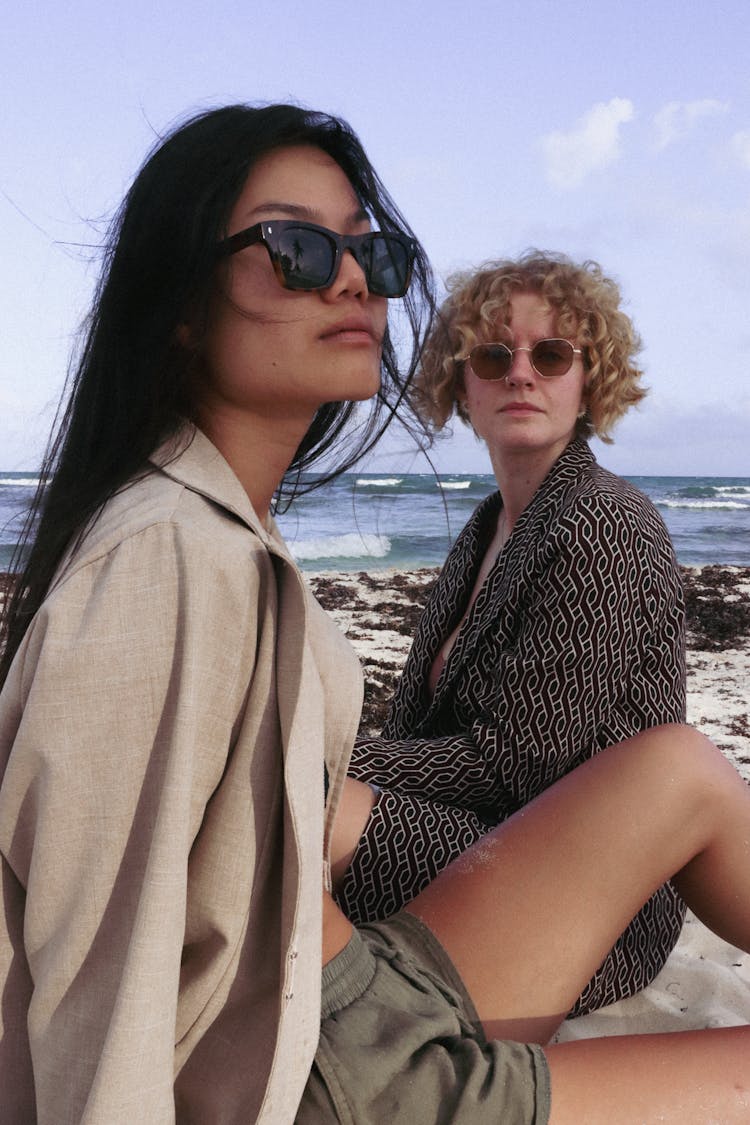 Women In Sunglasses Sitting On Beach