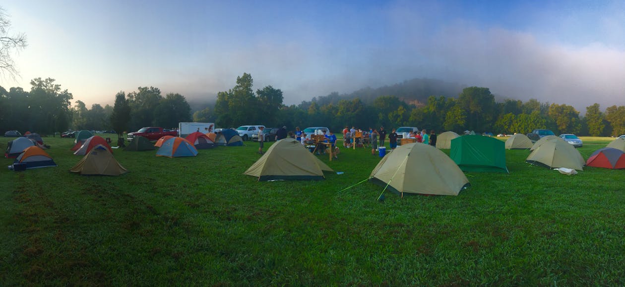 Free Tents on Green Grass Field Near Mountain Stock Photo
