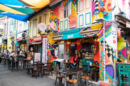 People Eating on the Street Outside a Restaurant