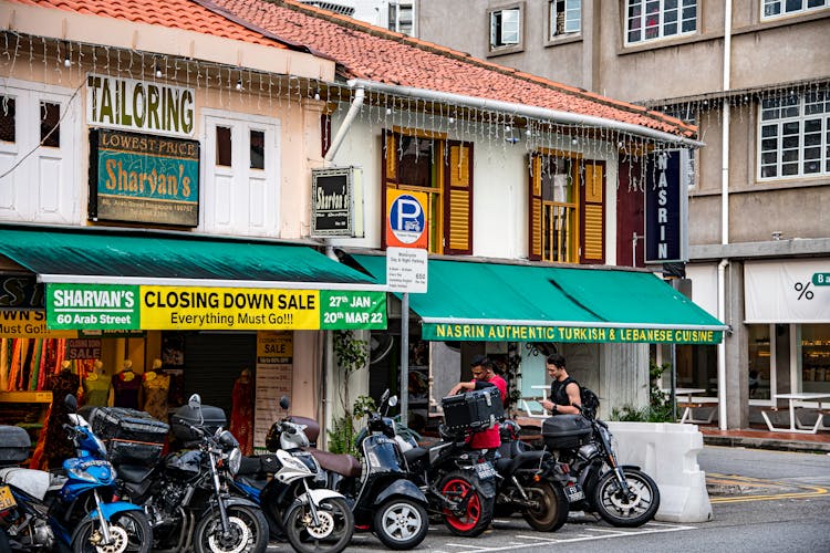 Motorcycles Parked Outside A Tailoring Shop