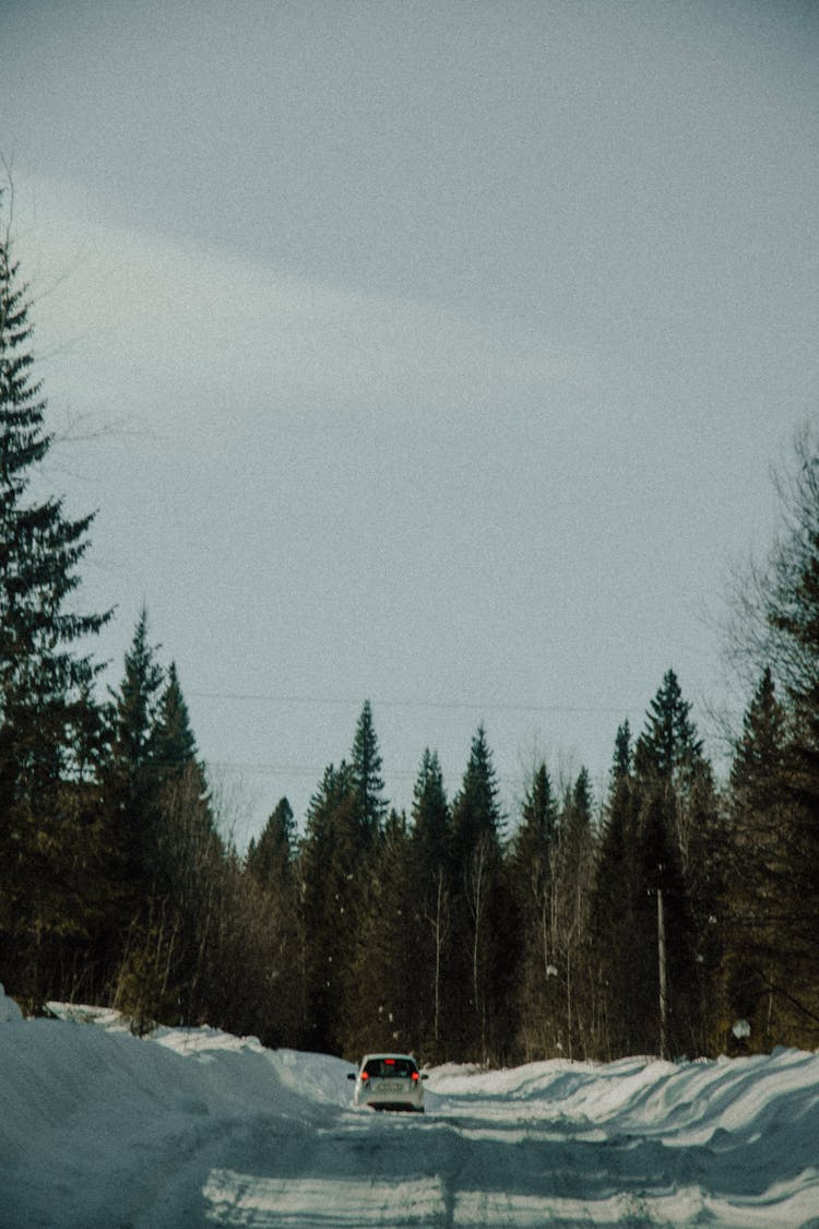 Car Driving On A Road Covered With Snow