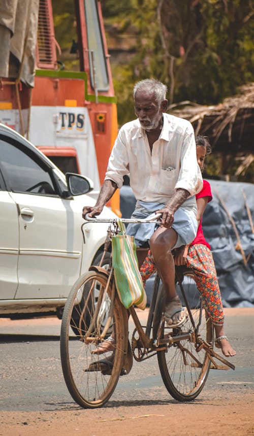 Elderly Man with Child on Bike