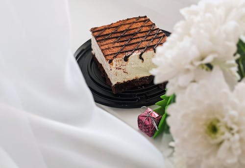 Free Brown and Black Chocolate Cake on White Ceramic Plate Stock Photo