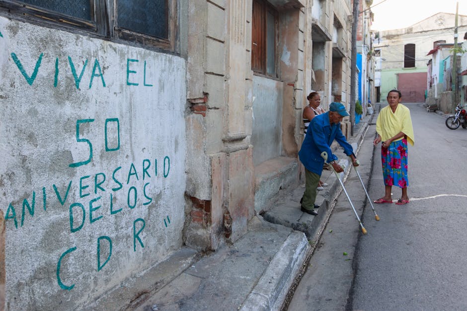 Colorful street scene with people and a mural celebrating 50 years of CDR.