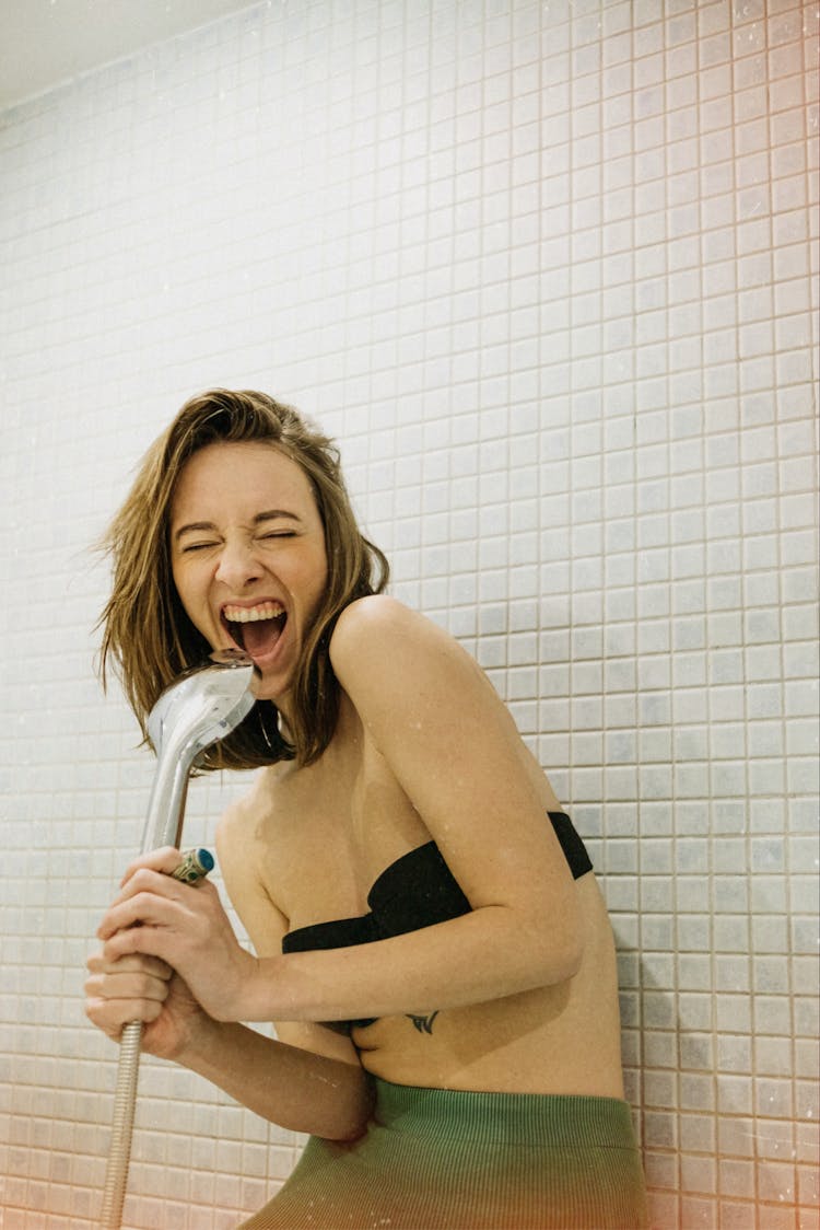 Woman Singing To Hand Shower 