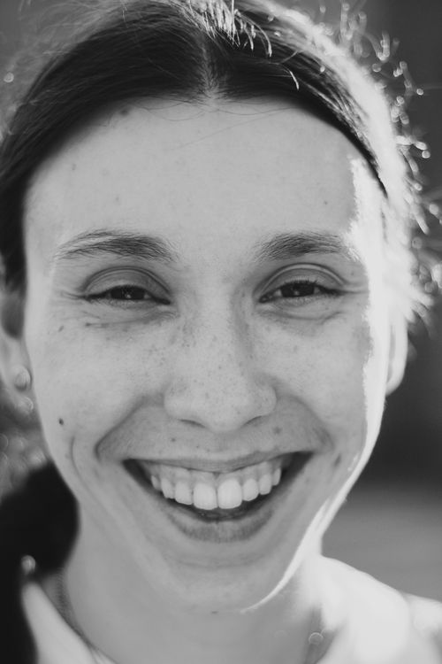 Free Close-up black and white portrait featuring a smiling woman with joyful expression. Stock Photo