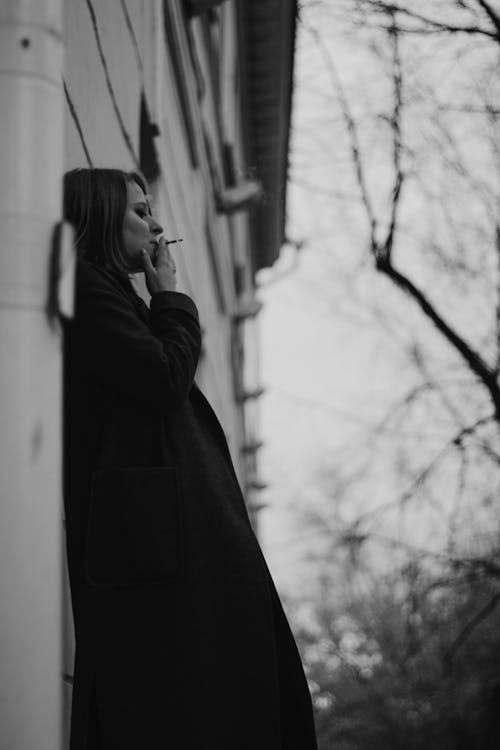Grayscale Photo of a Woman Smoking
