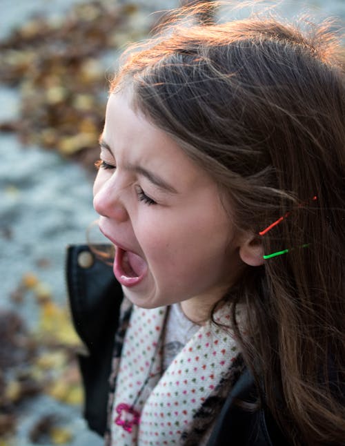 Girl Wearing Black Jacket and Gray Shirt With Open Mouth during Daytime