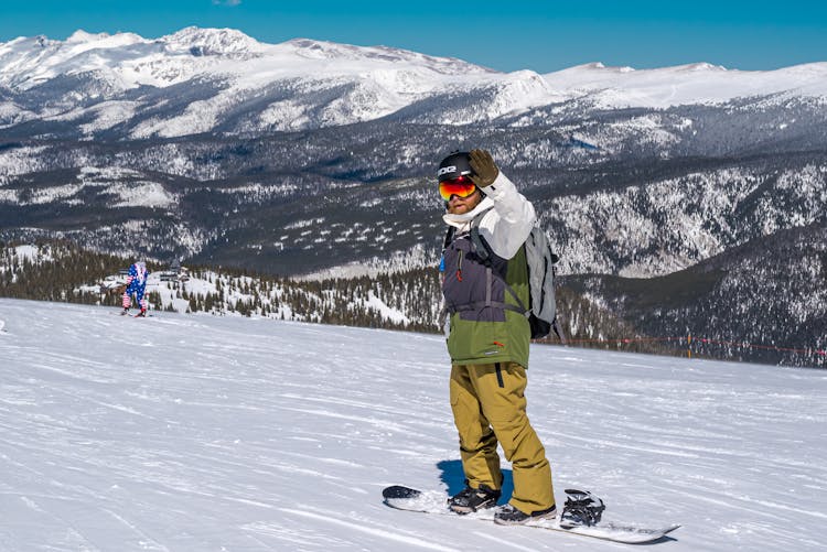 Man On Snowboard In Mountains