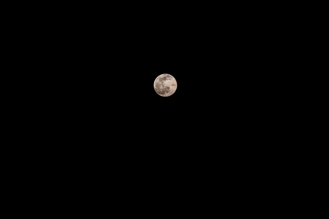 captivating image of the full moon shining brightly against a clear ni