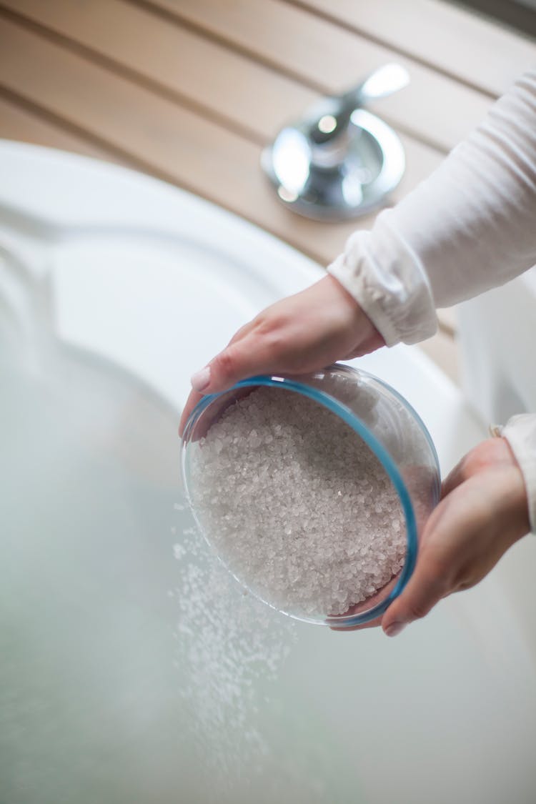 Woman Putting Salt In Jacuzzi