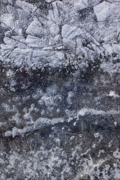 Free Close-up view of a textured icy surface with intricate frost patterns. Stock Photo