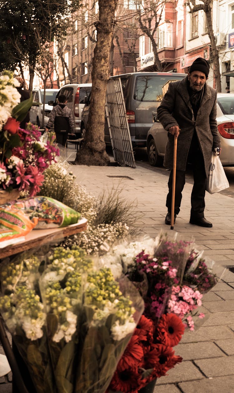 Elderly Man Walking On The Sidewalk