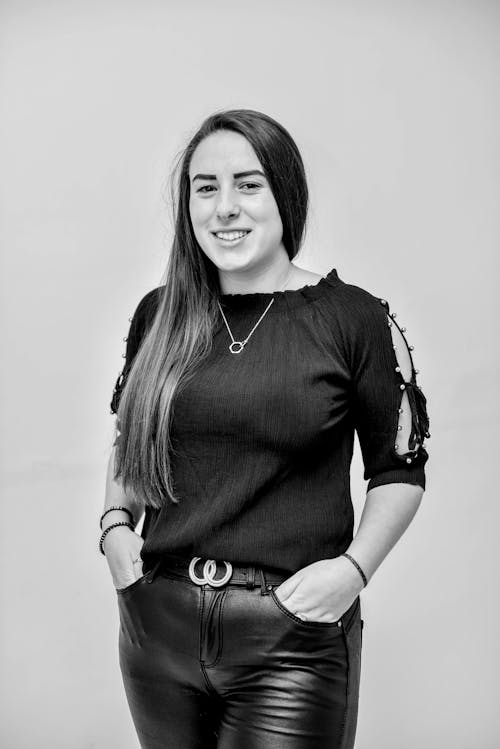 
A Woman Wearing a Blouse and Leather Pants