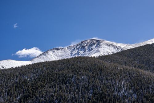 Free A stunning snow-covered mountain with a clear blue sky, showcasing a pristine winter landscape. Stock Photo