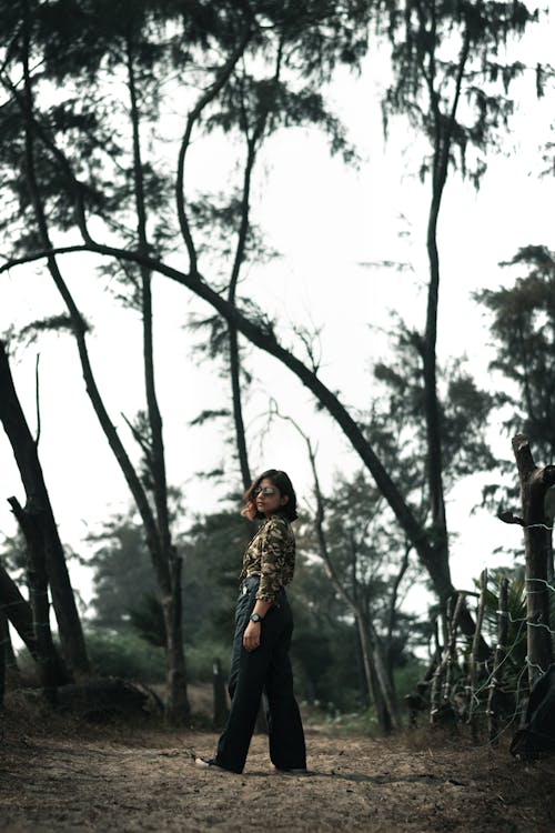 Free 
A Woman Wearing a Camouflage Top in a Forest Stock Photo