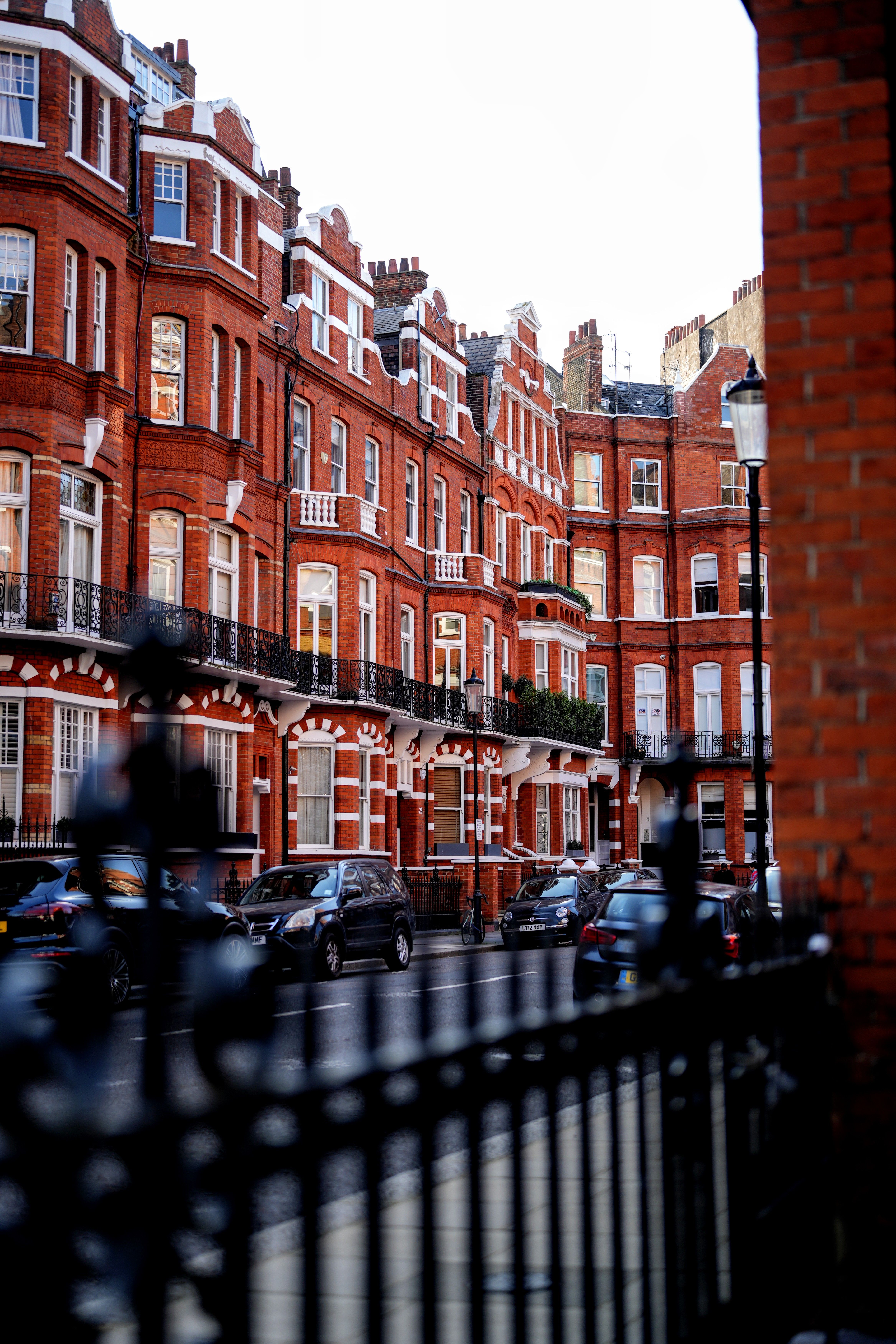 Cars Parked in Front of the Brown Building · Free Stock Photo