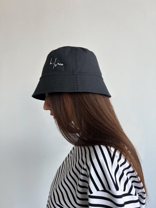 Free 
A Woman Wearing a Bucket Hat and a Striped Shirt Stock Photo
