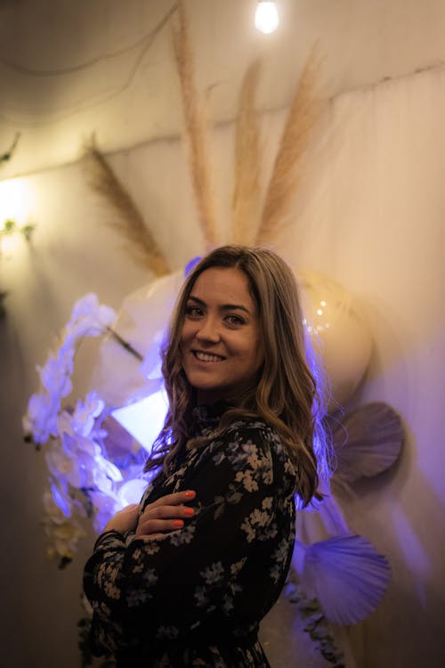 A Woman in Floral Dress Smiling at the Camera