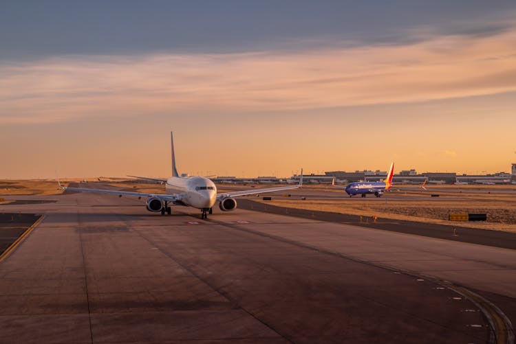 Airplanes On The Runway At Sunset 