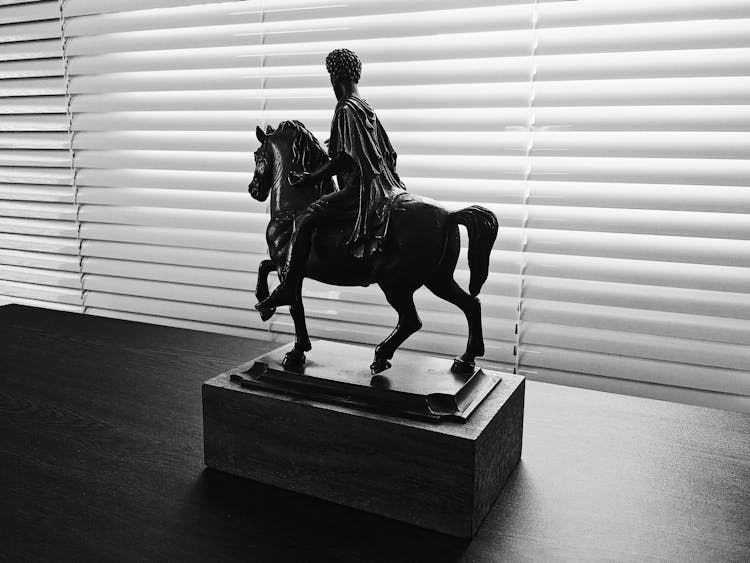 Man Riding On Horse Figurine