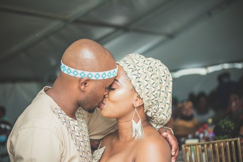 Free A couple shares a heartfelt kiss at their cultural wedding, reflecting love and tradition. Stock Photo
