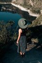 Woman in Black and White Polka Dot Dress Wearing White Sun Hat Standing on Green Grass