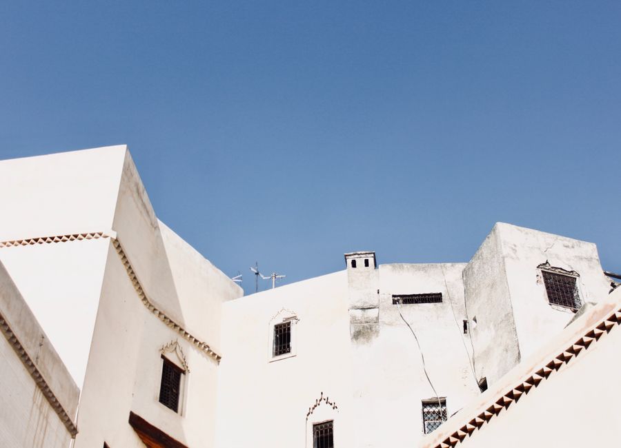 White buildings against a clear blue sky in the historic city of Fès, Morocco.