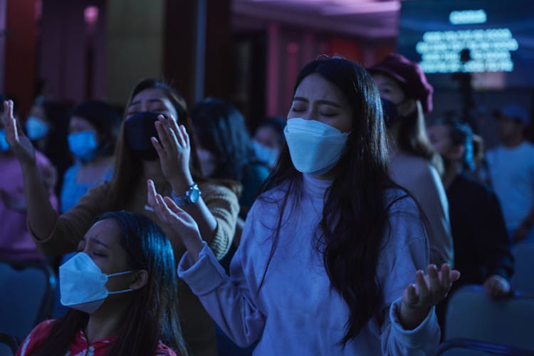 Group Of People In Face Masks Praying 