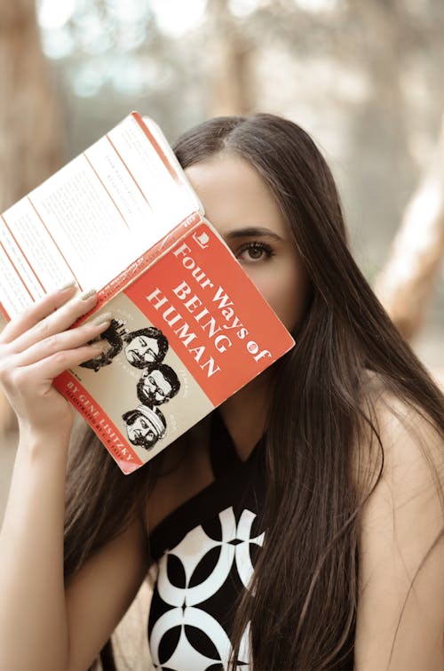 Free A Woman Holding a Book Stock Photo