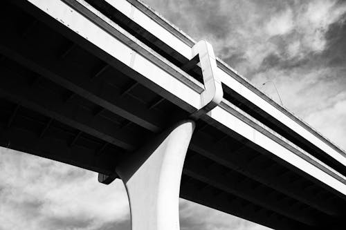 Grayscale Photo of Concrete Bridge