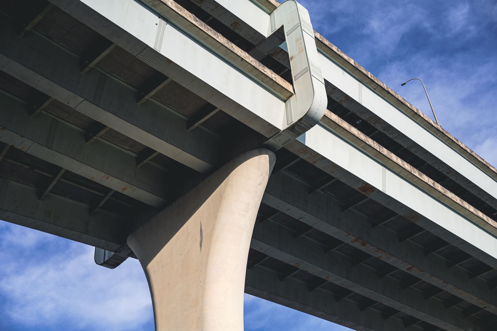 Underside of a curved highway overpass