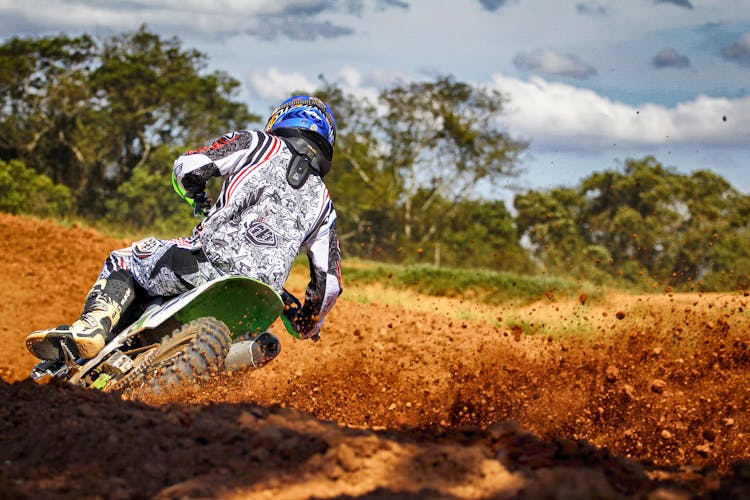 Man Riding Motocross Dirt Bike On Track