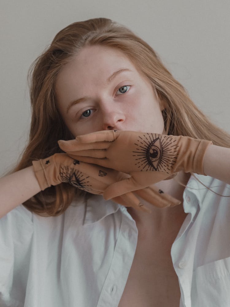 Woman Posing And Wearing Nude Gloves With Decorative Images