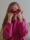 Woman Hiding Her Face With Hands With Flowers In-Between Her Fingers
