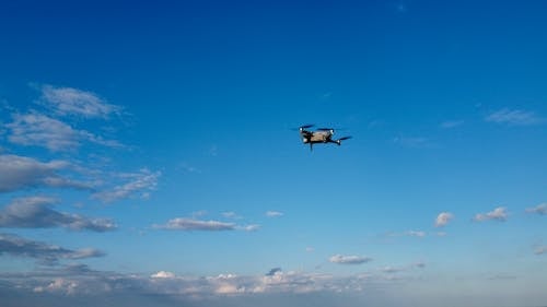 Free Drone Flying in the Blue Sky Stock Photo