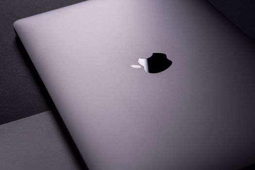 Close-up of a sleek, modern laptop featuring a minimalist design on a dark surface.