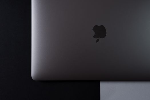 A minimalist top-down view of a laptop set against a black and white background.
