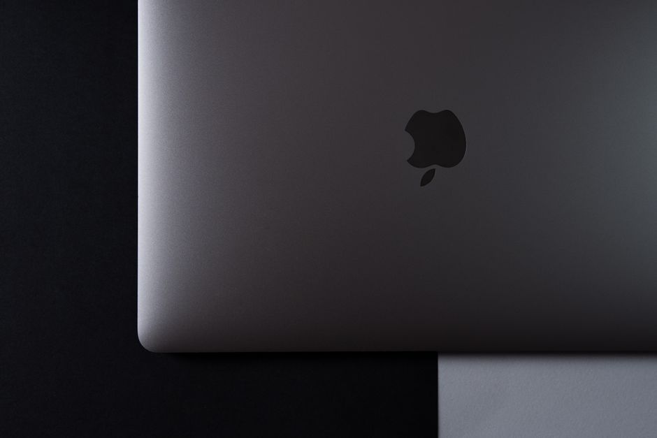 A minimalist top-down view of a laptop set against a black and white background.