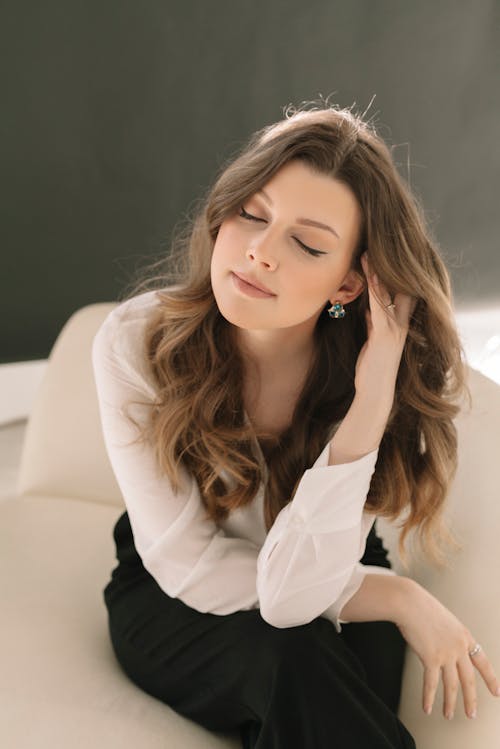 Free Portrait of Woman Sitting with Eyes Closed Stock Photo