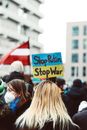 People Holding Blue and White Signage
