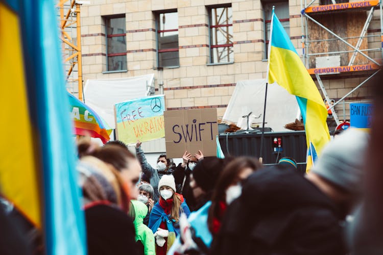 A Group Of People Protesting For Peace 