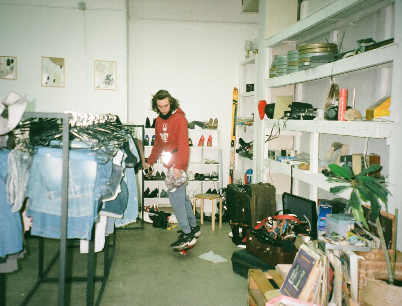 A collector measuring a vintage skateboard deck on a workshop table, ruler and provenance notes visible
