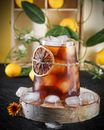 Clear Drinking Glass With Orange Juice on Brown Wooden Coaster