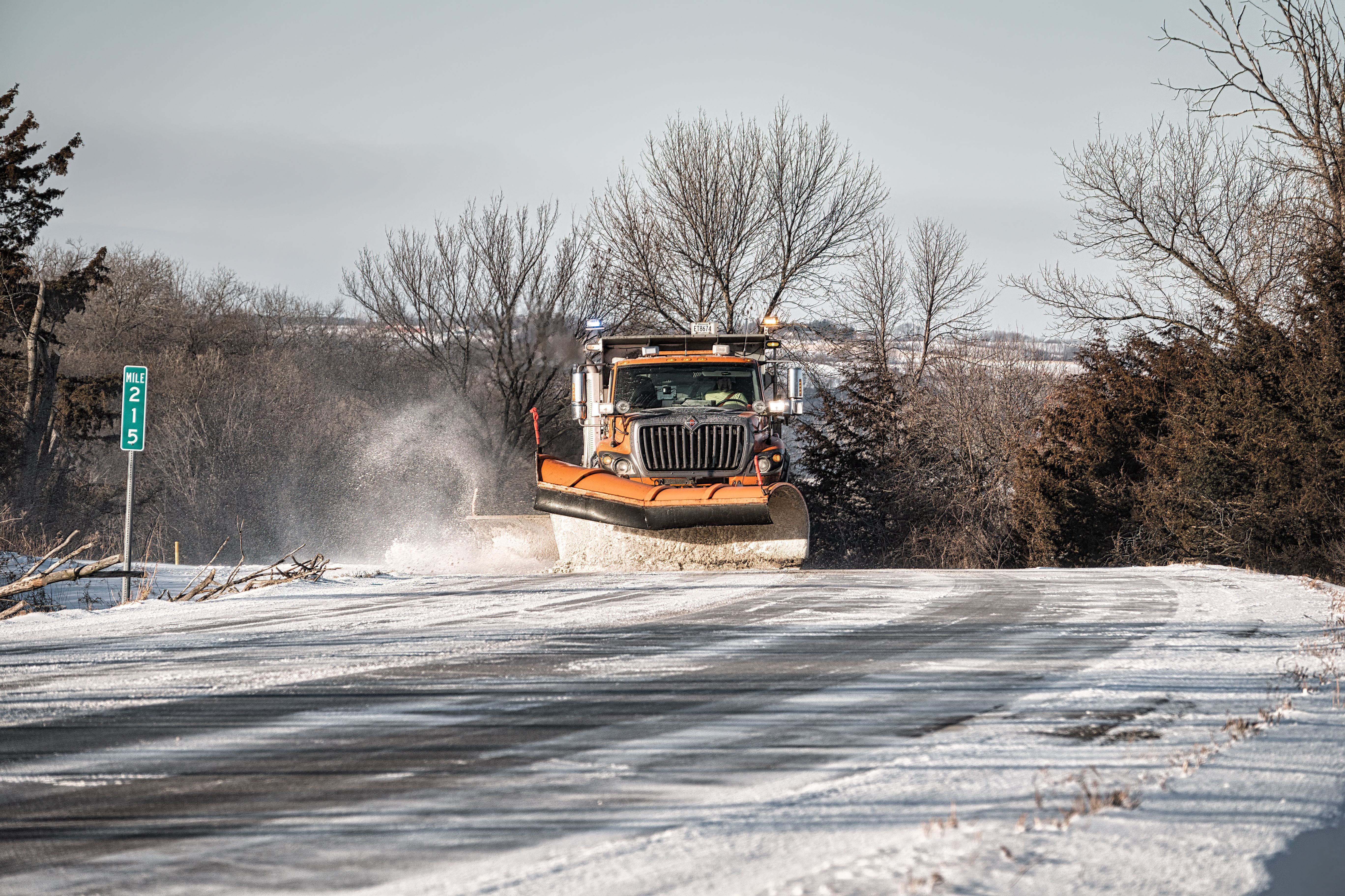 Yellow Truck Sweeping of the Snow on the Road