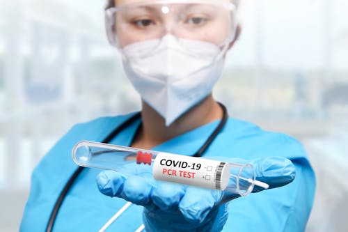 
A Medical Professional Holding a Test Tube for Testing Covid-19