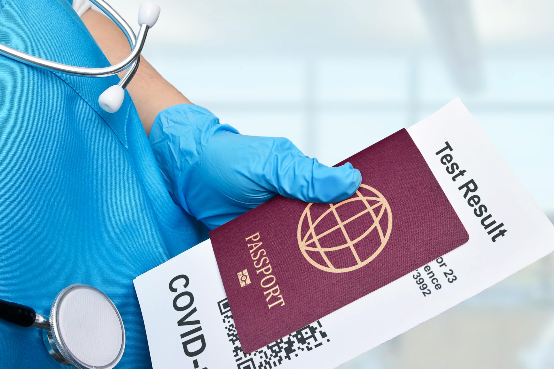 Close-up of a healthcare worker holding a passport and COVID-19 test result, symbolizing travel requirements.