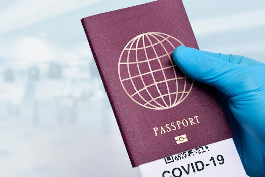Close-up of a gloved hand holding a passport with a COVID-19 ticket, symbolizing pandemic travel.