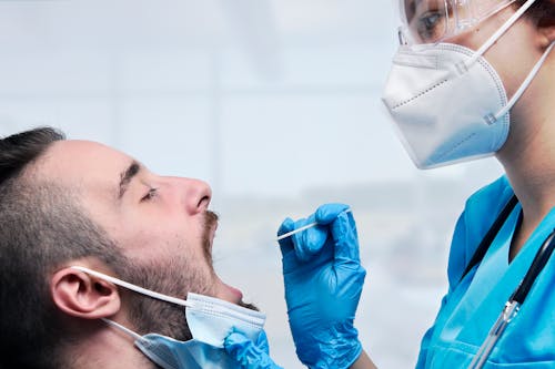 
A Medical Professional Swabbing a Patient