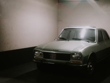 Classic retro car parked in a dimly lit indoor garage showcasing nostalgia.